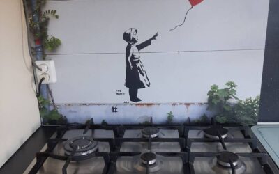 Review – spatscherm Banksy met uitsnede voor stopcontact